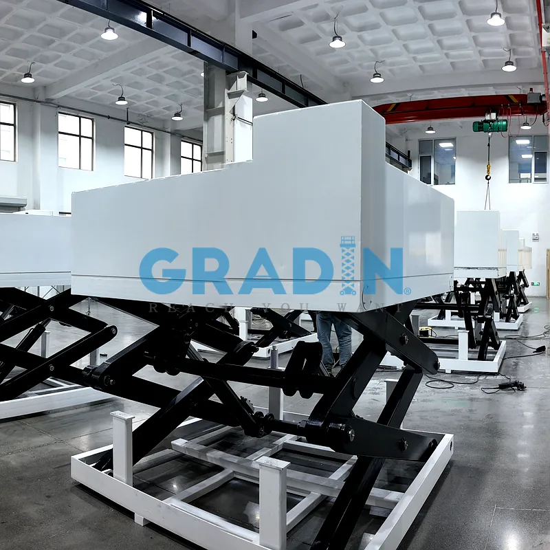 Heavy-duty assembly line scissor lift platform integrated into an industrial manufacturing environment for vertical material handling.